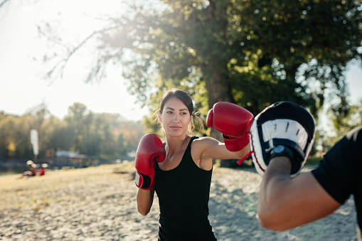 Woman boxing with a friend
